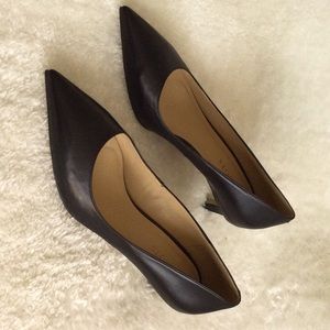 Classic black leather Talbots pumps .